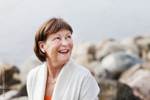 Happy senior woman looking up outdoors