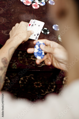 Cropped image of man playing poker at home photo