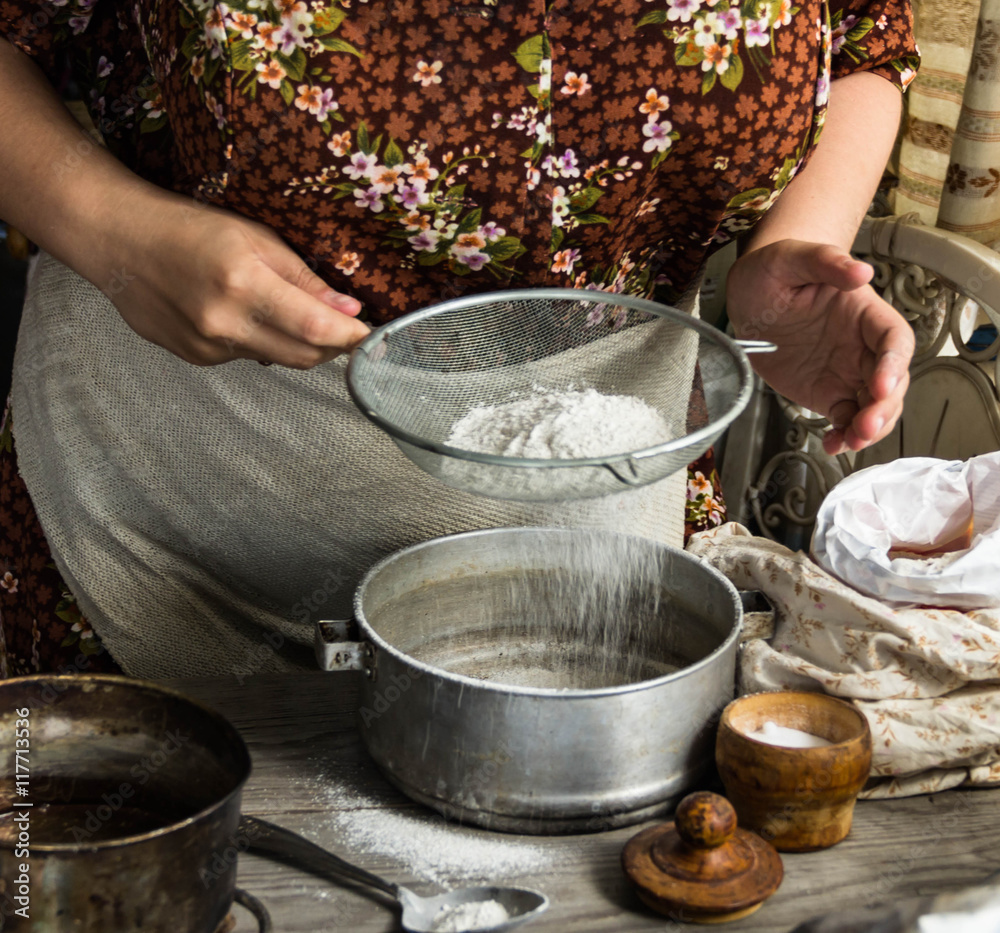 Woman preparing dough basis.Ingredients for baking.Female hands spilling powder on dough.Making dough by female hands.Cooking and baking concept
Woman preparing dough basis.Ingredients for baking.Female hands spilling powder on dough.Making dough by female hands.Cooking and baking concept
