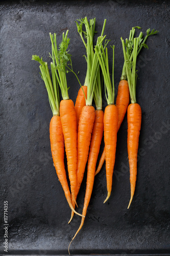 Organic carrots on black background