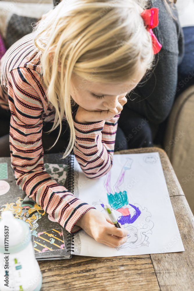 Little girl drawing at table in house Stock Photo | Adobe Stock