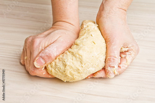 Woman hands preparing dough 