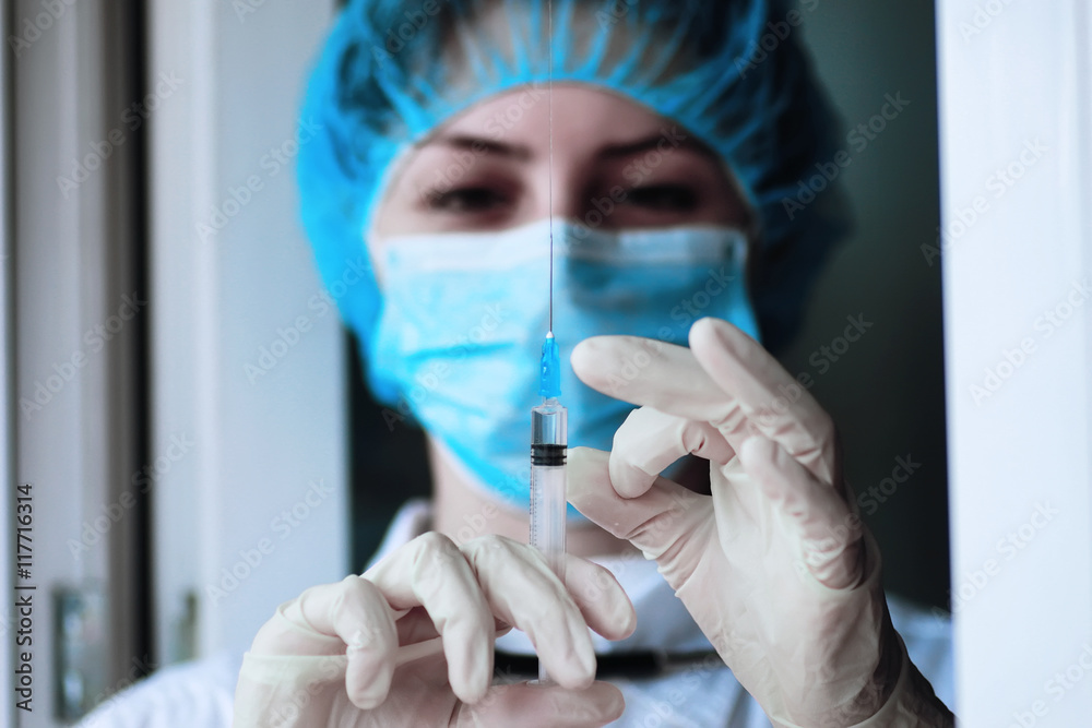 health worker dials the vaccine into a syringe health worker dials the vaccine into a syringe