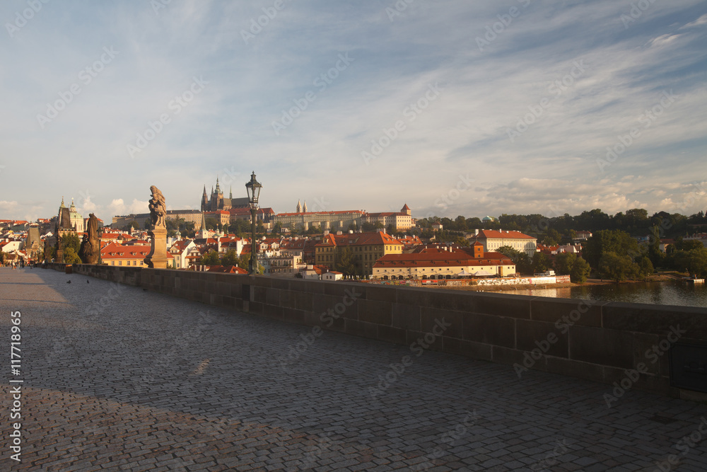 The statues of the Charles Bridge in the rays of the rising sun
