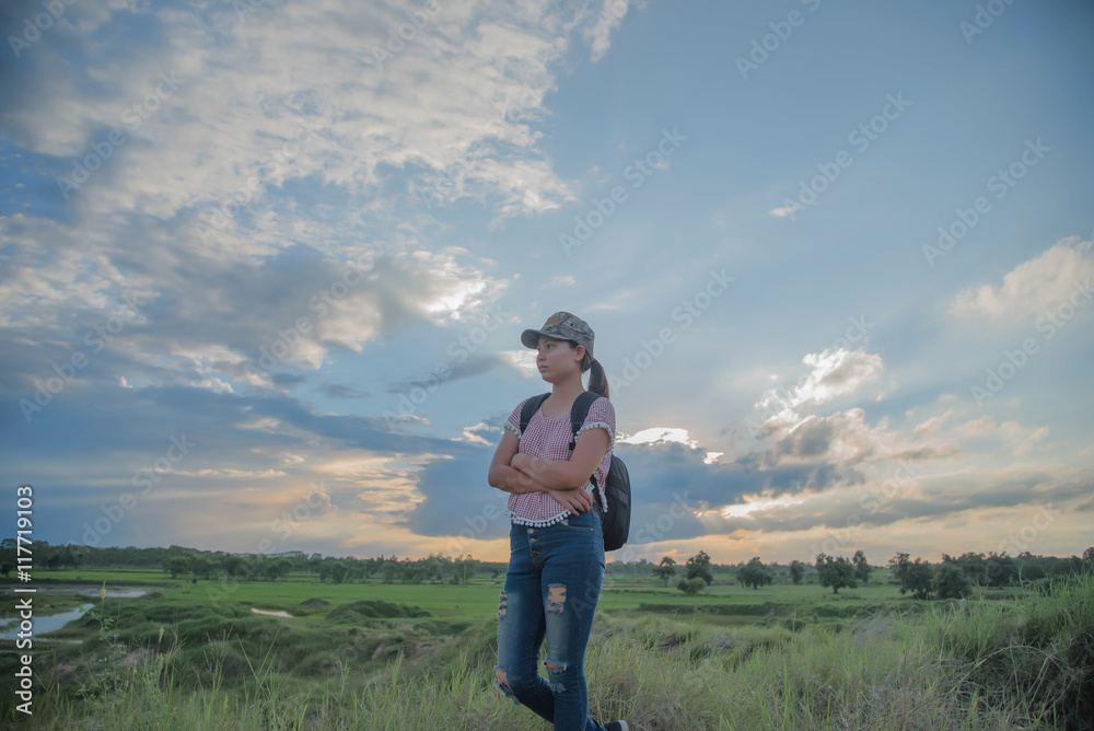 cheering young woman hiker open arms to snow mountains in the di