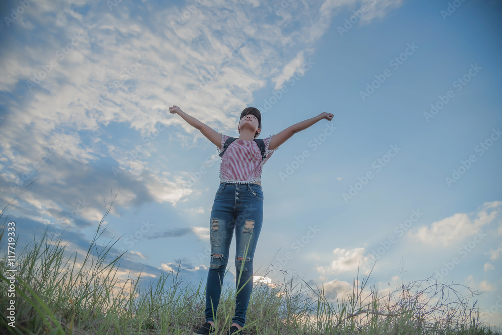 cheering young woman hiker open arms to snow mountains in the di cheering young woman hiker open arms to snow mountains in the di