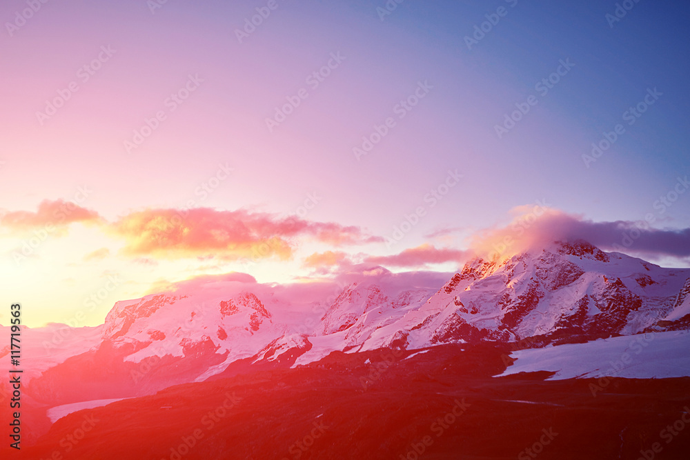 beautifull cloudy sunrise in the mountains with snow ridge. Alps. Switzerland, Trek near Matterhorn mount.