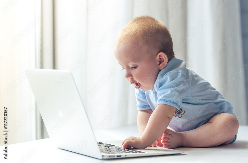 Cute baby with laptop
