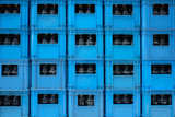 PILES OF BOTTLE CONTAINERS
Blue plastic container filled with drinking bottle.
