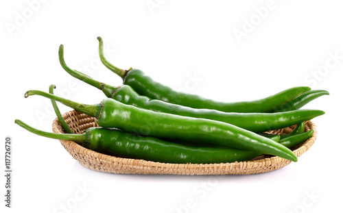 Green chilli pepper in basket on white background