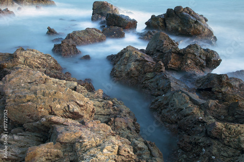 long exposure of sea and rocks © Tazzjang