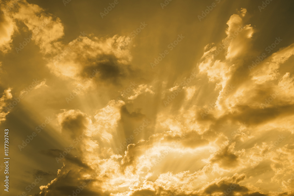 Sunset rays through the clouds on sky: can be used as background