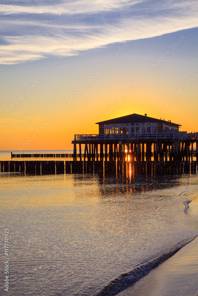 Restaurant at wooden pier on the baltic sea during sunrise. Ustronie Morskie, Poland. Restaurant at wooden pier on the baltic sea during sunrise. Ustronie Morskie, Poland.
