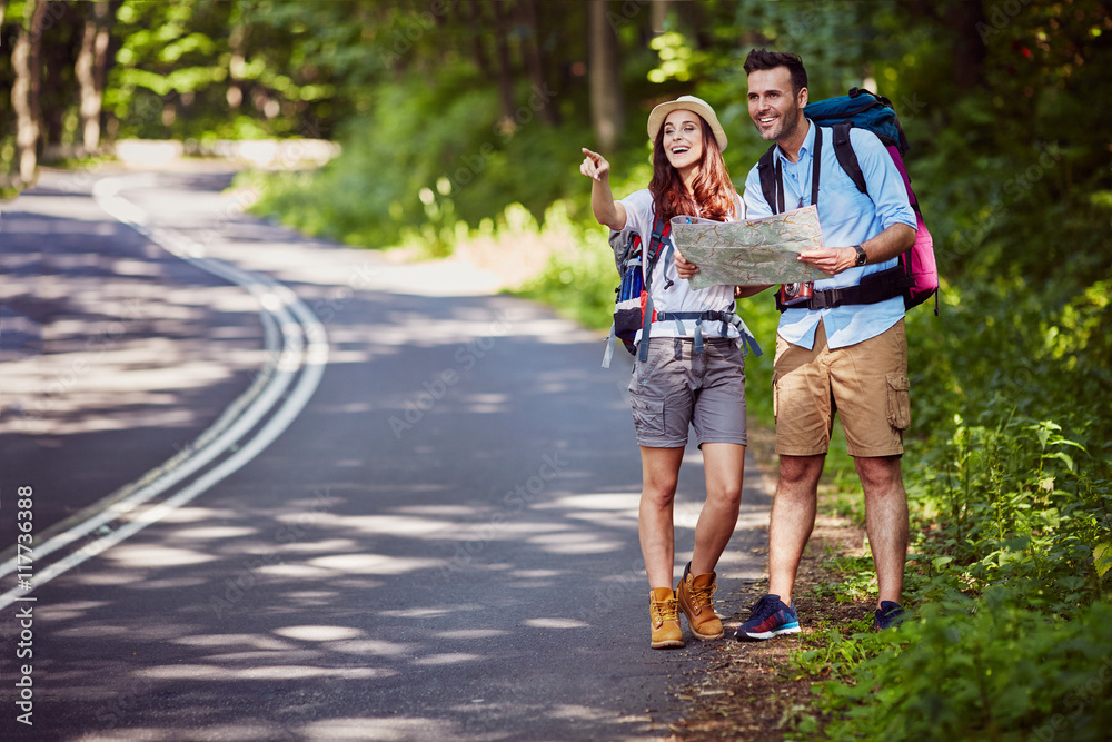 Fototapeta premium Happy couple hiking with backpacks