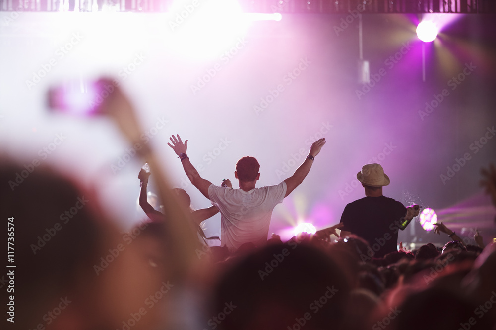 Fototapeta premium Fans Sitting On Friend's Shoulders At Music Festival