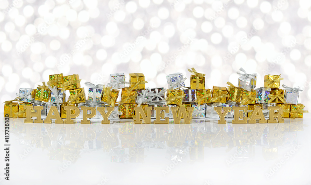 Happy New Year golden text and golden and silver gifts on a boke Happy New Year golden text and golden and silver gifts on a boke
