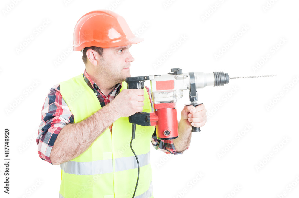 Workman with helmet holding the drilling machine Workman with helmet holding the drilling machine