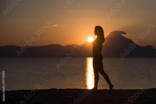 Beautiful woman silhouette on the beach © ancamilushev