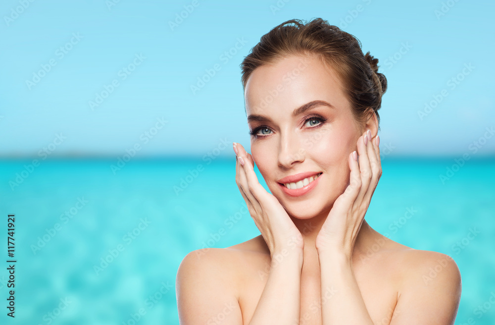 beautiful young woman touching her face