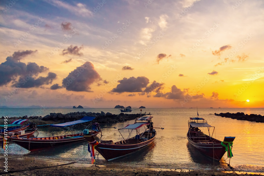 Fishing boats on the beach at sunset background