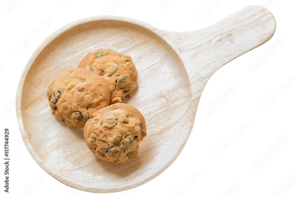 Fototapeta premium Oat cookies with pumpkin seeds and raisin on a wooden plate.