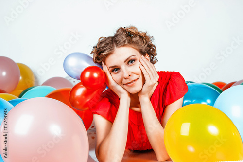 portrait of a girl with balloons smiling