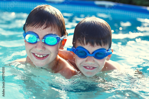 Happy little kids in goggles smile in pool © sakkmesterke
