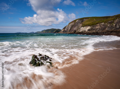 Waves crash against a rock photo