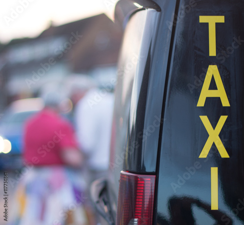 Billede på lærred Taxi Rank with black mini cab and yellow sign