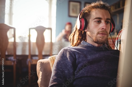 Hipster man listening music at home photo