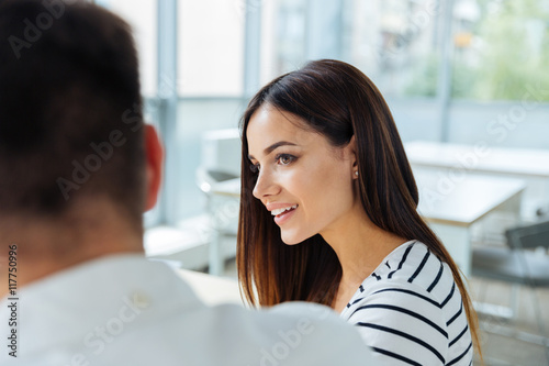 Businesswoman sitting and working with her colleague in office