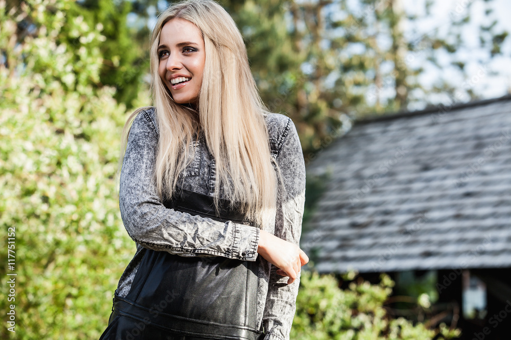 Outdoors portrait of beautiful young blond woman. Outdoors portrait of beautiful young blond woman.
