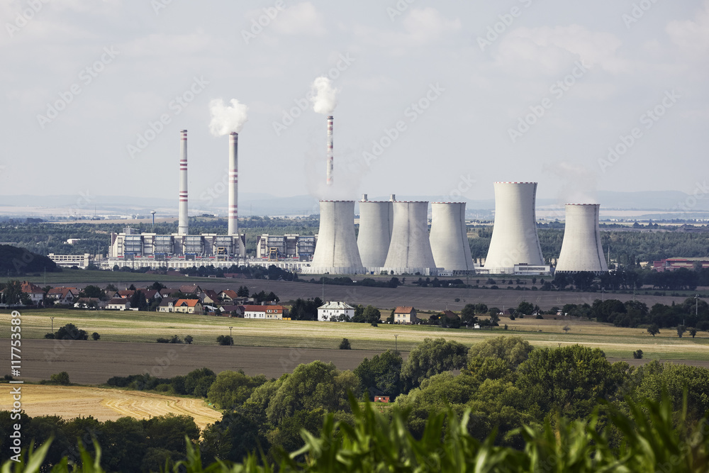 A coal-fired power station in the distance in agricultural landscape. Pocerady, Czech republic A coal-fired power station in the distance in agricultural landscape. Pocerady, Czech republic