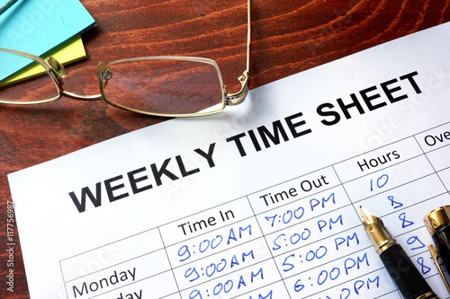 Paper with weekly time sheet on a table. photo