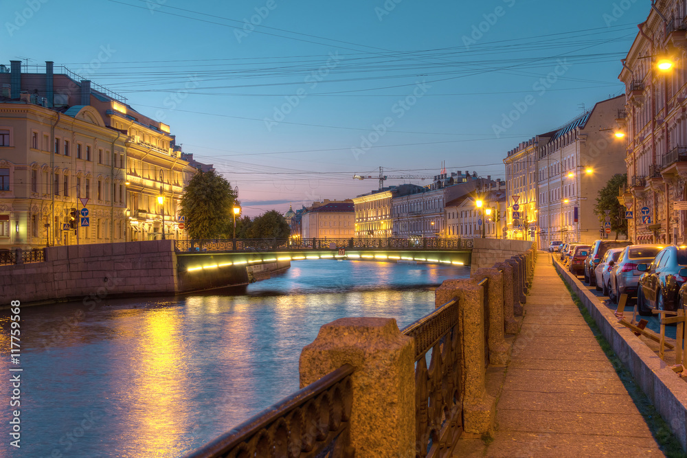 Night view on illuminated Moyka River and Fonarny Bridge from embankment, St. Petersburg, Russia.
