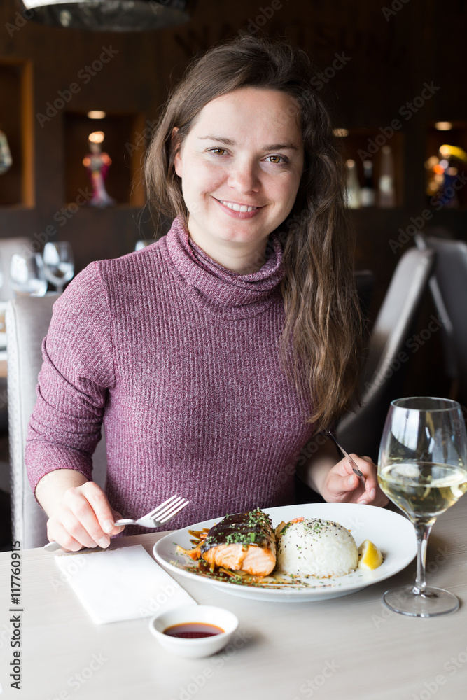 Happy woman spending her time in restaurant