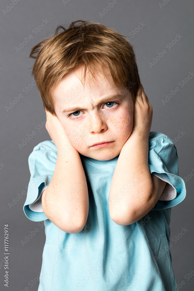 unhappy little kid disliking his education, protecting his closed ears