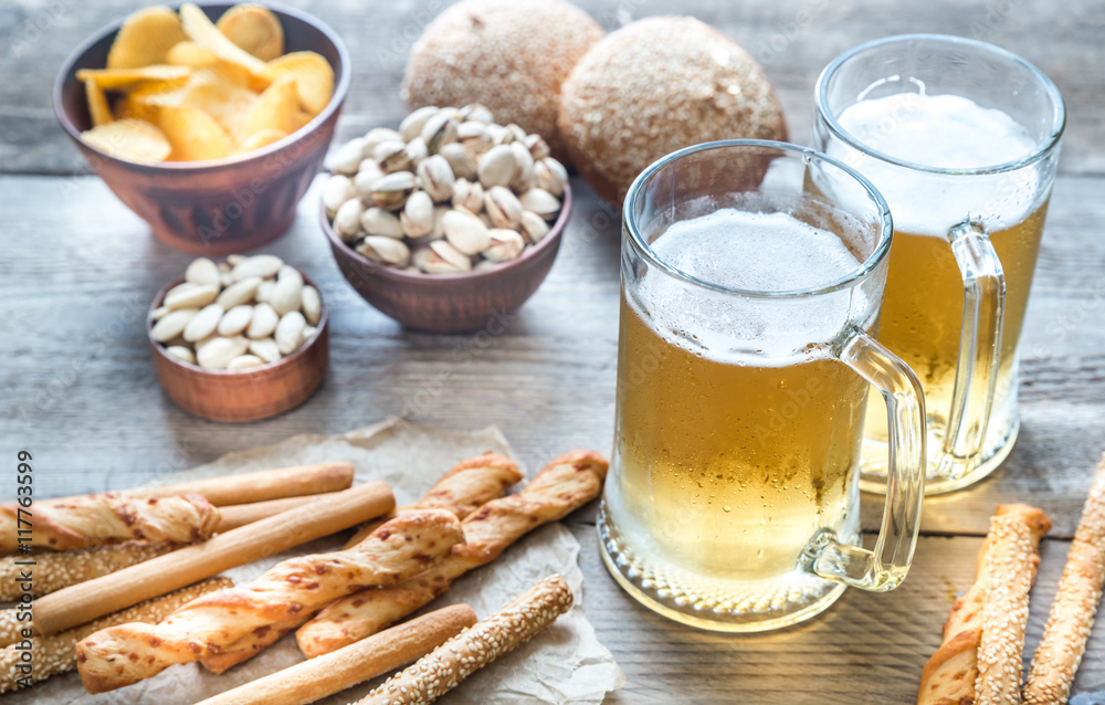 Two glasses of beer with appetizers