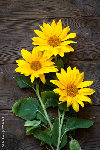 Fototapeta Naklejka Na Ścianę i Meble -  Sunflowers at wooden table.