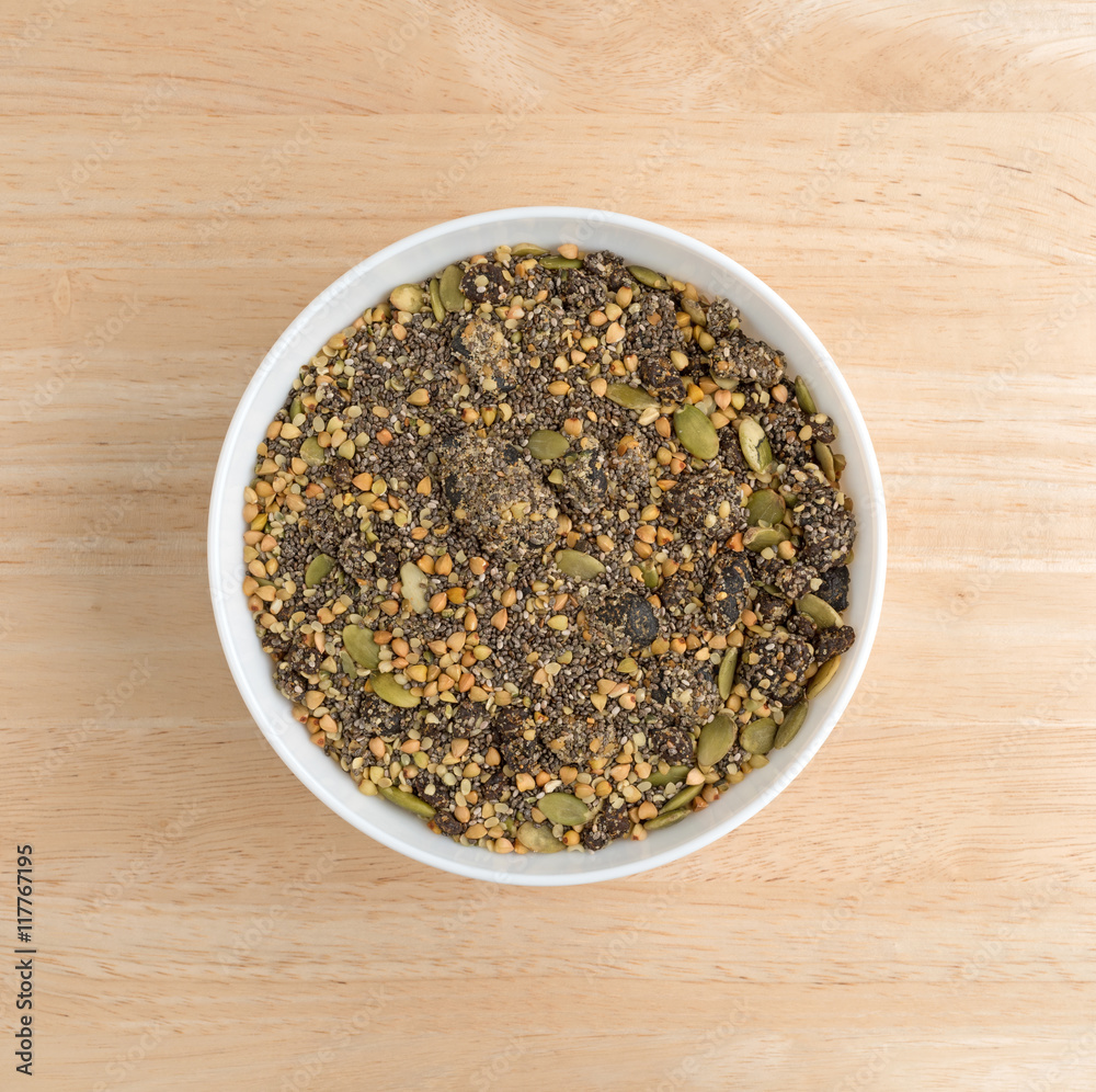 Chia cranberry and pumpkin seeds breakfast cereal in bowl on a wood table top. Chia cranberry and pumpkin seeds breakfast cereal in bowl on a wood table top.
