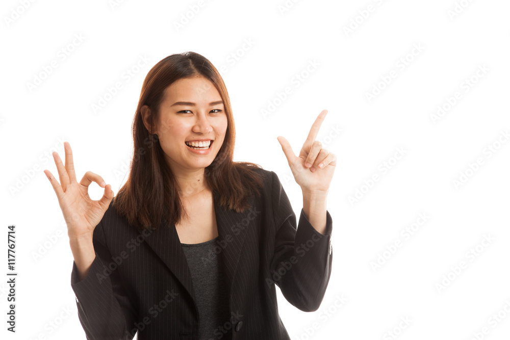 Young Asian business woman point and show OK. Young Asian business woman point and show OK.