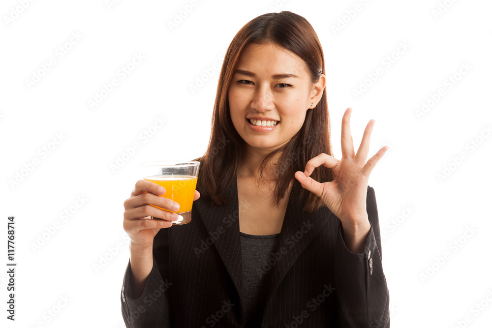 Young Asian woman drink orange juice show OK sign. Young Asian woman drink orange juice show OK sign.