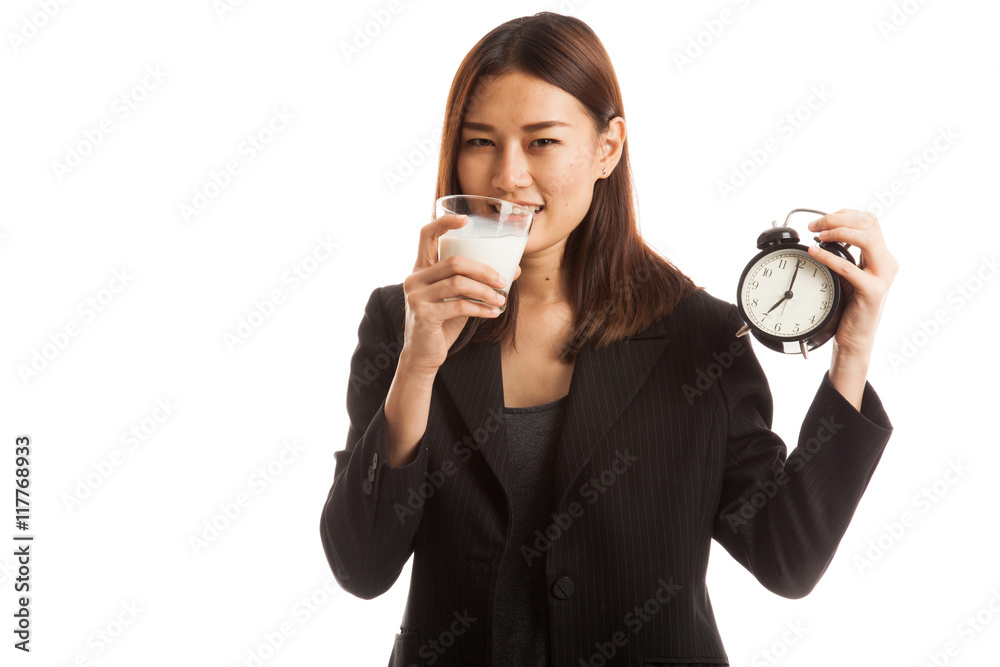 Healthy Asian woman drinking glass of milk hold clock. Healthy Asian woman drinking glass of milk hold clock.