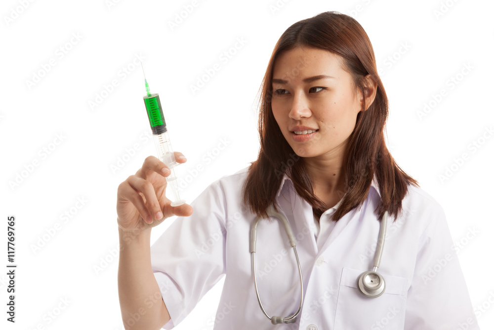 Young Asian female doctor look at syringe. Young Asian female doctor look at syringe.