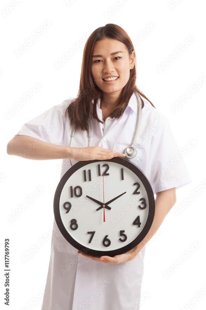 Young Asian female doctor happy show a clock. Young Asian female doctor happy show a clock.