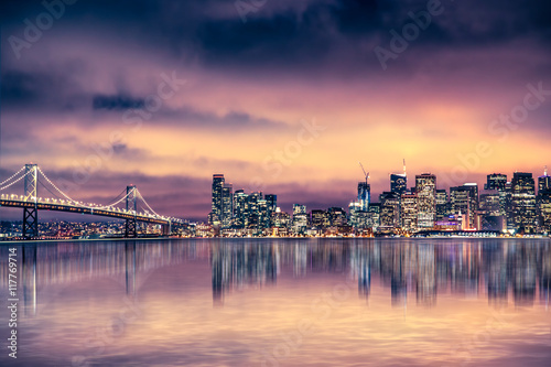 San Francisco California skyline with lights and bay under colorful sunset sky photo