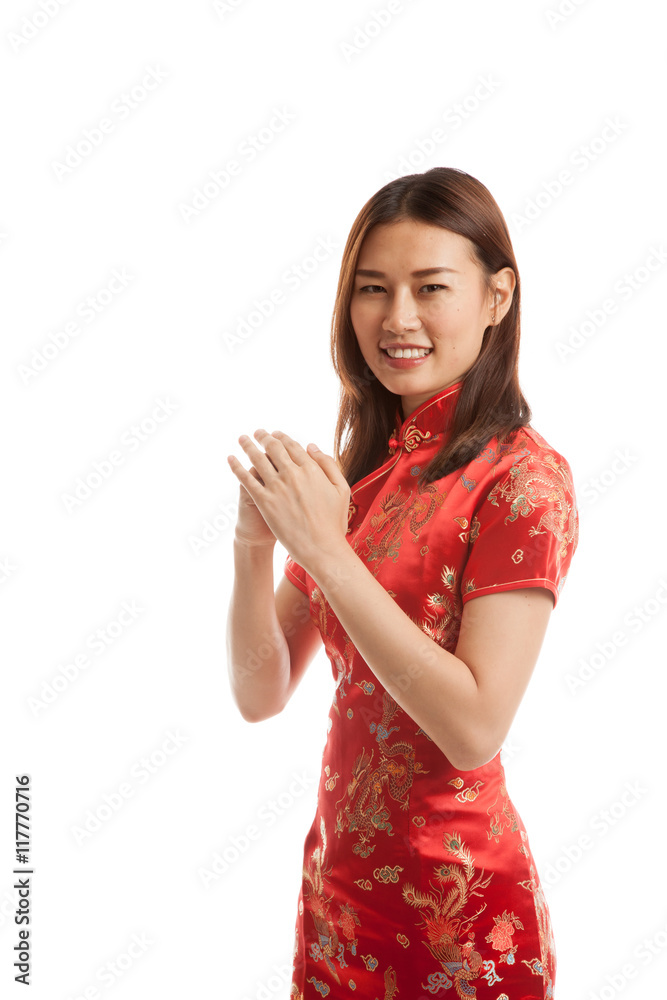 Asian girl in chinese cheongsam dress with gesture of congratula Asian girl in chinese cheongsam dress with gesture of congratula
