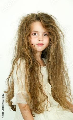 little girl with long messy hair Stock Photo | Adobe Stock