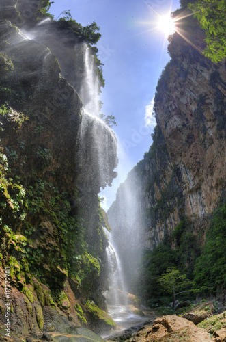 Tropical waterfall in canyon