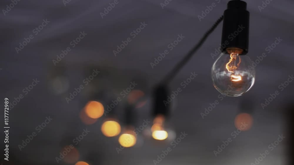 View of lighted light bulbs in terrace of summer restaurant. Sparkle. Objects. Shine View of lighted light bulbs in terrace of summer restaurant. Sparkle. Objects. Shine
